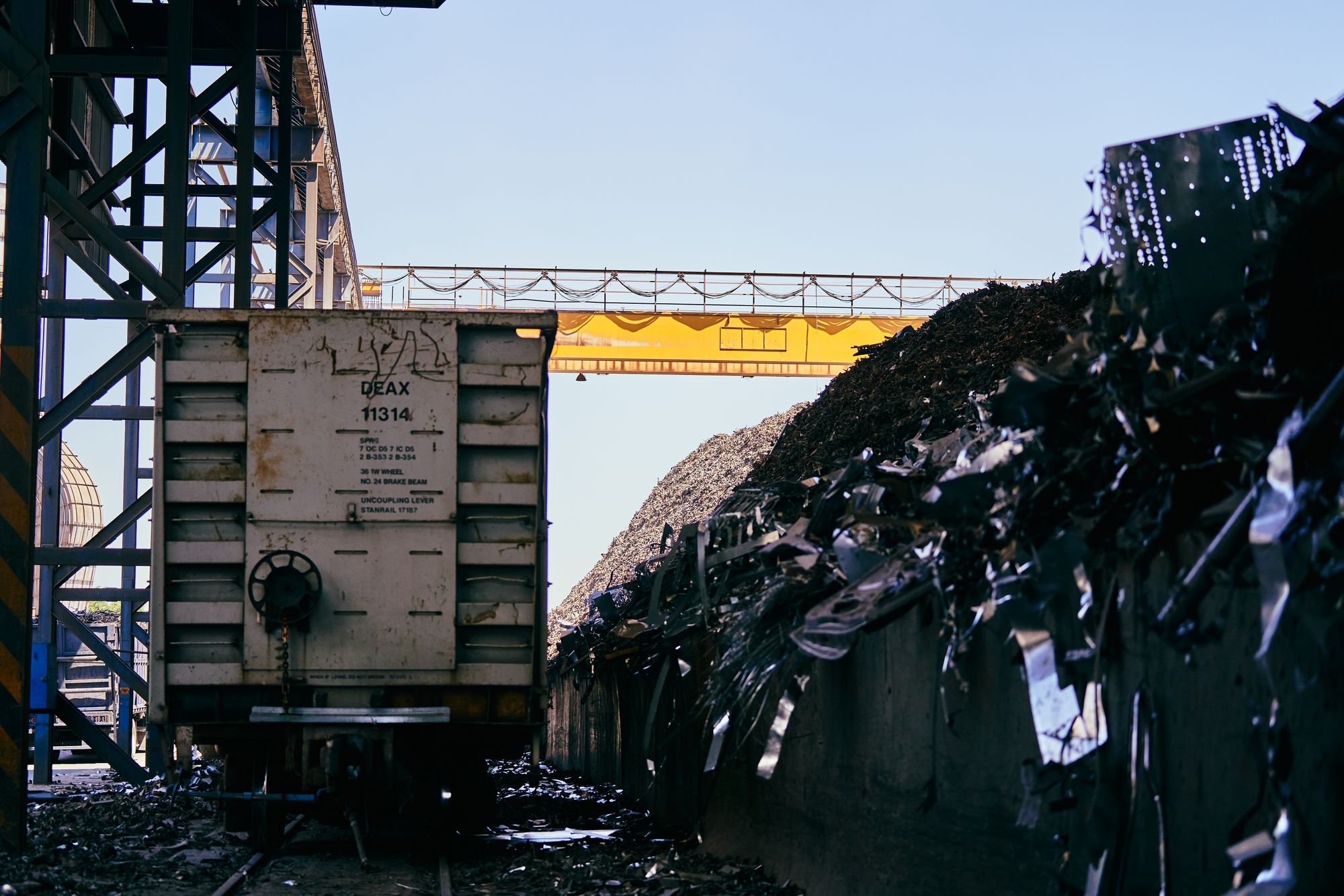 Schrottplatz mit Förderband und Metallschrott in einem Entsorgungs- und Recyclingbetrieb
